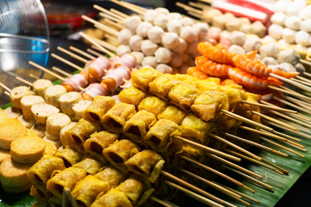 四川小吃店家將各式食材串在竹籤上，泡一下雞湯，再放到辣椒油裡面，口味很受歡迎。圖/123RF圖庫